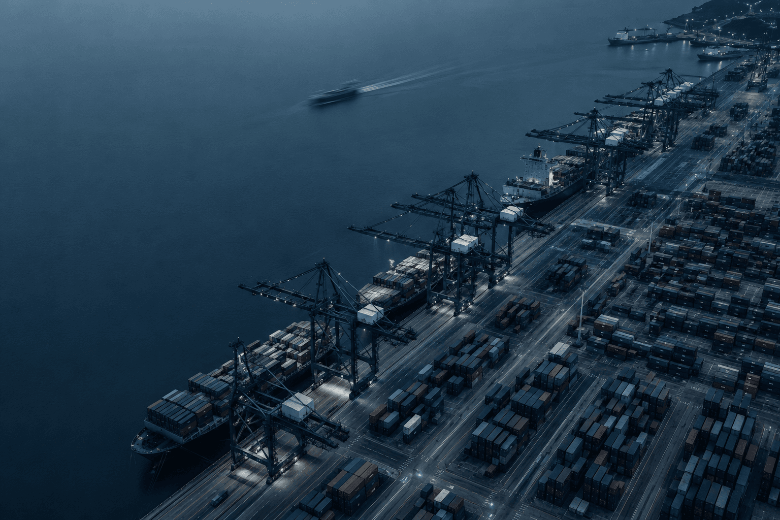 A container terminal at dusk, seen from above.